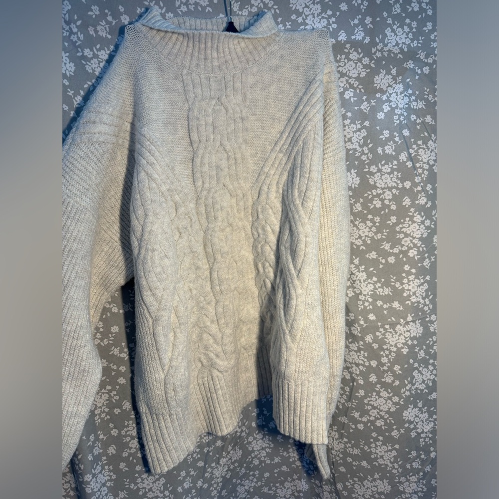 Cream colored short turtle neck wool sweater